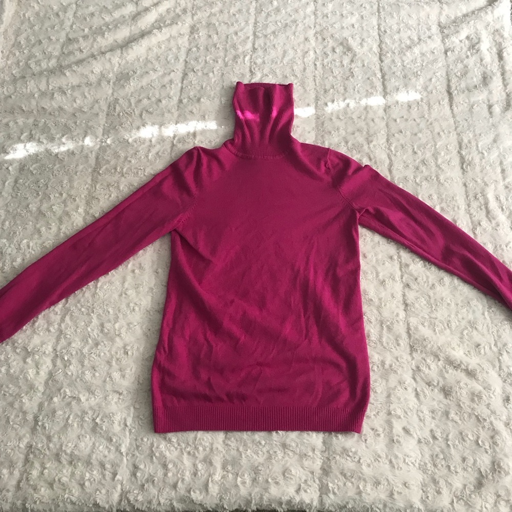 Pink turtleneck.
